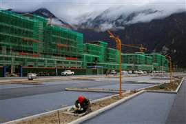 A construction site in Chna with buildings surrounded by scaffolding.