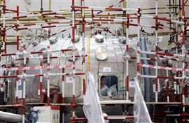 Men work inside a HL-2M Tokamak nuclear fusion reactor, dubbed as the "artificial sun", under construction in Chengdu, Sichuan province. 