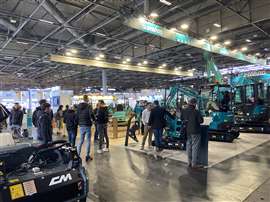 Visitors to Intermat 2024 in Paris survey a range of new excavators.